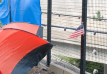 The Reality of Peoria’s Homeless Encampments Tent of Homeless person with American flag